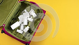 Travel Health Insurance Concept. Trip Pink Suitcase, Bag Full of Medication: Pills, Tablet