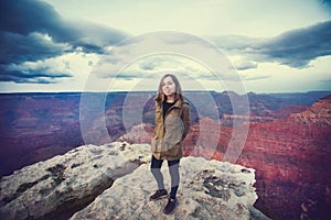 Travel hiking photo of young beautiful teenager student at Grand Canyon viewpoint when sunset, Arizona