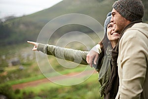 Travel, hiking and pointing with couple in mountains together for love, dating or sightseeing. Smile, environment or