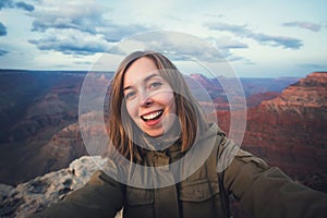 Travel hiking selfie photo of young beautiful teenager student at Grand Canyon viewpoint in Arizona