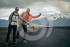 Travel hitchhiker couple on a road photo