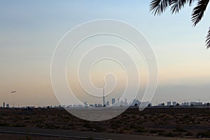 Travel holiday Dubai skyline burj khalifa airplane skylne sky date palm tree silhouette