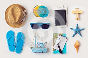 Travel holiday vacation concept with beach and travel items organized on white background
