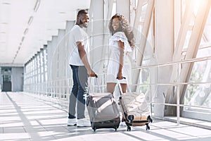 Travel And Honeymoon Concept. Young Black Couple Posing In Airport Before Departure