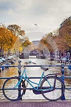 Travel Ideas. City of Amsterdam. Traditional Dutch Bicycle In Front of The Canal Fence in Amsterdam