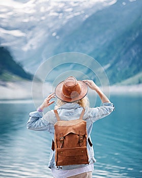 Travel image. Traveler look on the mountain lake. Travel and active life concept.