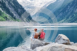 Travel image. Travelers team look on the mountain landscape. Travel and active life concept with team.