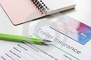 Travel insurance application form on white desk background