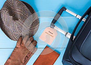 Travel insurance concept. Suitcase, hat, gloves, passport case, insurance tag. Insurance tag text is easily replaceable.