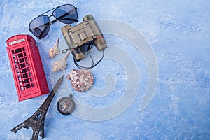 Travel items / accessories on blue wooden background with empty space for text.