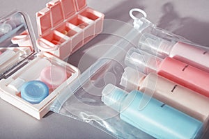Travel kit. Set of bottles for cosmetic products in transparent bag, kit for contact lenses, pill organizer.