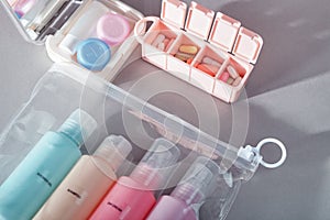 Travel kit. Set of bottles for cosmetic products in transparent bag, kit for contact lenses, pill organizer.