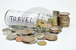 Travel lable in a glass jar with coins spilling out