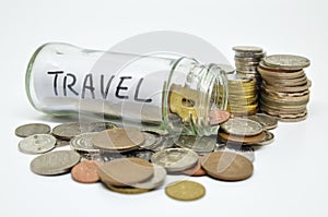 Travel lable in a glass jar with coins spilling out