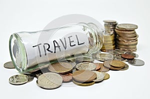 Travel lable in a glass jar with coins spilling out