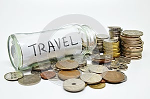 Travel lable in a glass jar with coins spilling out