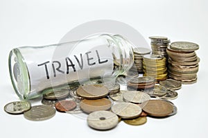 Travel lable in a glass jar with coins spilling out