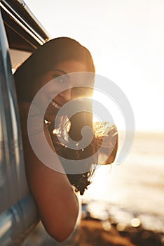 Travel at least once a year. an attractive young woman enjoying a road trip.