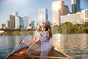 Travel and leisure commercial model, woman on canoe boat kayak relaxing enjoying summer fun day on river in Austin downtown