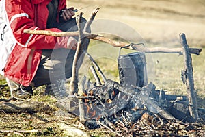 Travel life style mountains hiking camp site fire with bowler cooking dish