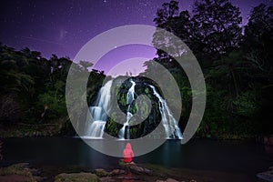 Travel lifestyle concept waterfall, lake and mountains night sky landscape on background outdoor