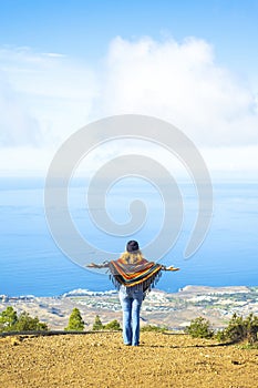 Travel lifestyle people copy space background image. One woman enjoy amazing trip destination opening arms agains a blue sky and