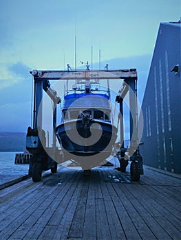Travel lift launching a gillnetter in Port Moller, Alaska photo