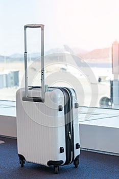 Travel luggage suitcase at the airport terminal in waiting area passenger lounge for departure flight for business transportation