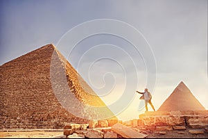 Travel man in hat stand background Egyptian pyramid sunset Giza Cairo, Egypt