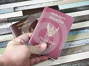 A travel man holding Thailand passport .