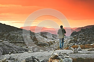 Travel Man walking enjoying sunset mountains