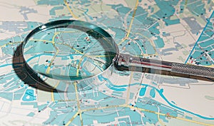 Travel map with magnifying glass, searching city locations. Geography route concept, glass lens