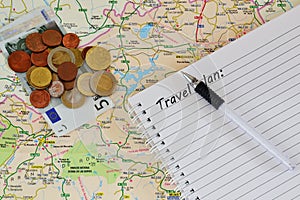 Travel map, notebook and money