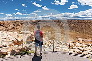 Travel in Meteor Crater, man hiker with backpack enjoying view, Winslow, Arizona, USA photo