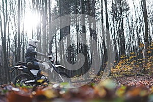 Travel motorcycle off road Motorcyclist gear, A motorcycle driver looks in autumn forest, adventure concept, active lifestyle,