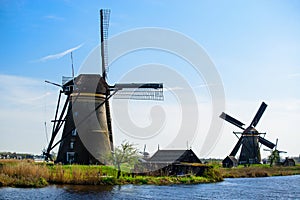 Travel in The Netherlands. Traditional Holland - Windmills in Kinderdijk - famous tourist site at sunny spring day