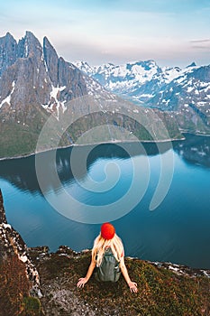 Travel in Norway tourist woman enjoying view hiking in mountains outdoor with backpack healthy lifestyle