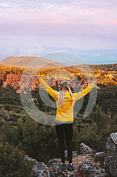 Travel outdoor woman hiking solo exploring canyon in Albania adventure lifestyle hiker raised hands in mountains