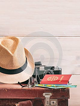 Travel packing concept, vintage suitcase and passport on white background - copy space