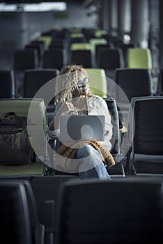 Travel people concept with lonely modern beautiful woman sit down on seats at airport or station waiting to start and enjoy the photo