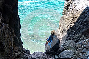 Travel people women tourist in a cave near the sea in Keo Sichang, Thailand.