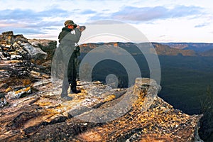Travel photographer photographing the landscape from  Lincoln Rock Lookout at sunrise of the Grose Valley located within the Blue
