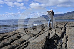 Travel photographer photographing Tessellated Pavement in Tasman Peninsula Tasmania Australia