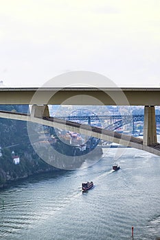 Travel Places Ideas. Line of Tourist Boats and Porto Cityscape at Daytime with Ponte Infante D Henrique in Background in Portugal