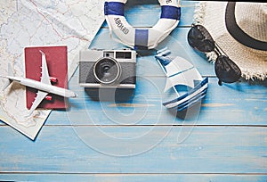 Travel Plan. Traveler planning trip summer travel on the beach with Traveler accessories, retro camera, airplane and passport,