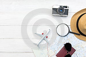 Travel Plan. Traveler planning trip summer travel on the beach with Traveler`s accessories, retro camera, airplane and passport,