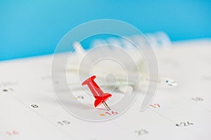 Travel planning with airplane destination points on calendar pin / travel time or plan for travelling concept