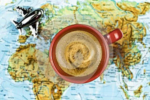 Travel planning concept with coffee, plane and map