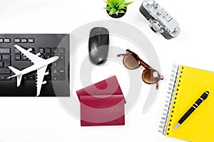 Travel planning concept at office with passports sunglases and computer photo