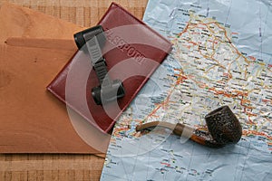 Travel planning - map with passport, shells and binoculars